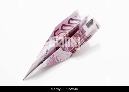 Paper aeroplane folded from 500 Euro banknote Stock Photo