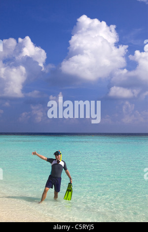 Man leaves with flippers and mask of ocean, Maldives Stock Photo