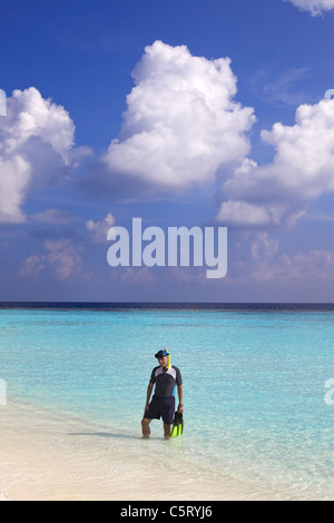 Man leaves with flippers and mask of ocean, Maldives Stock Photo