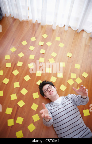 man stretched his arms out lying on the floor Stock Photo