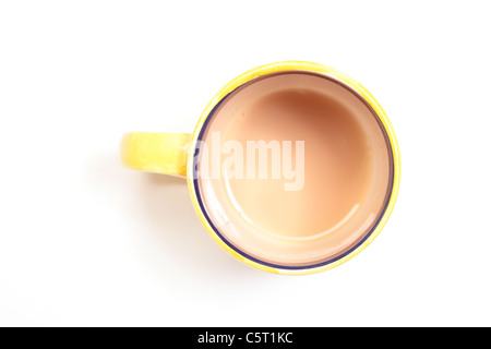 Tea in a yellow and blue mug, looking down almost gone. Stock Photo