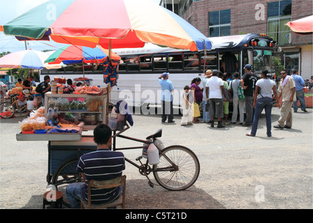 Stalls providing food and drink to people waiting for buses in San Ignacio town centre, Cayo, west Belize, Central America Stock Photo