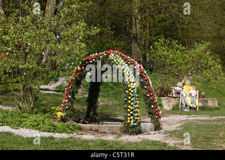 Germany Bavaria Franconia Franconian Switzerland Wiesenttal Trainmeusel Osterbrunnen Easter well decoration with easter bunnies Stock Photo