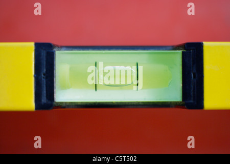 Close up of spirit level on red background Stock Photo