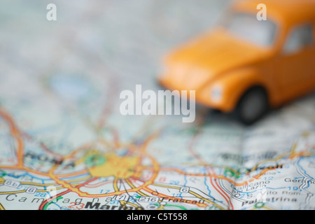 Italy, Rome, Close up of beetle toy car on road map Stock Photo