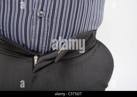 Close up of mature man with tight trousers against white background Stock Photo