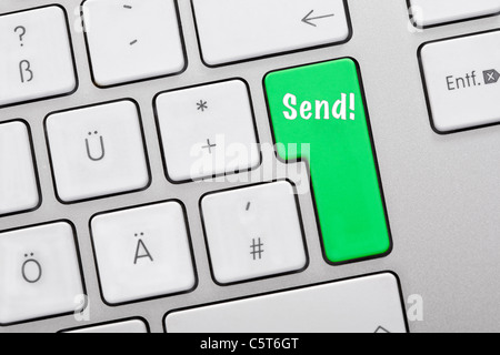 Illustration of keyboard having green key with send sign, close up Stock Photo