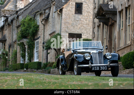 1955  Vintage MG TF 1500 car parked outside houses in the medieval town of Burford . Cotswolds, England Stock Photo