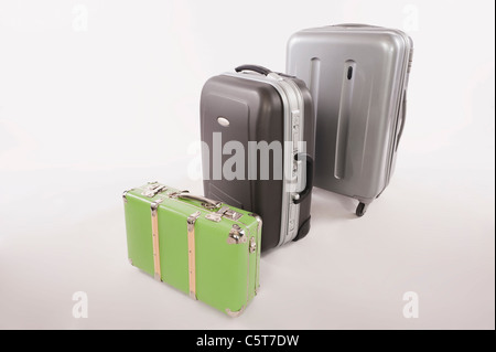 Variety of suitcases and luggages in a row against white background Stock Photo