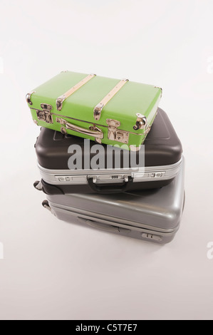 Stack of suitcases and luggages against white background Stock Photo