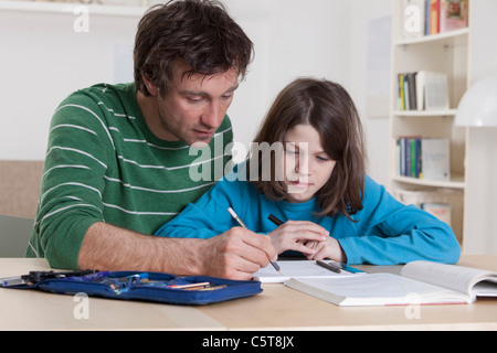 Germany, Bavaria, Munich, Father helping son with homework Stock Photo