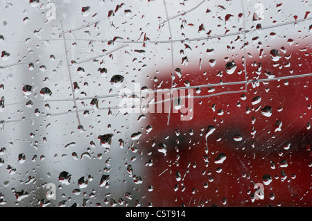 Raindrops on window pane, close-up Stock Photo