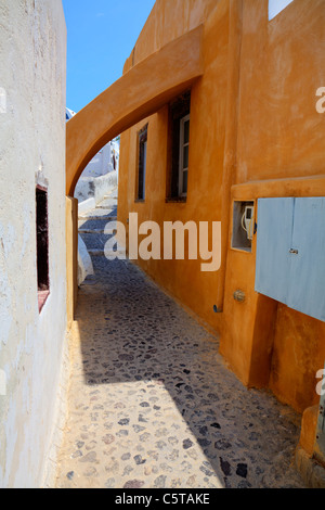Santorini, Greek Island, Cyclades, Greece, small street in Oia, La, arch over cobbled path and steps into town Stock Photo