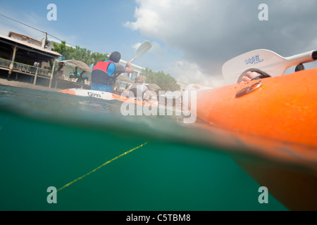 A couple in a double kayak at Skala Eresou on Lesbos, Greece. Stock Photo