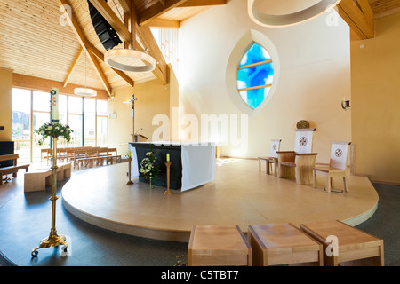 Altar seats and stained glass windown in modern church Stock Photo
