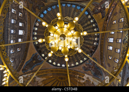 A view of the central dome seen through the center chandelier. Interior of Haghia Sophia, Istanbul, Turkey Stock Photo