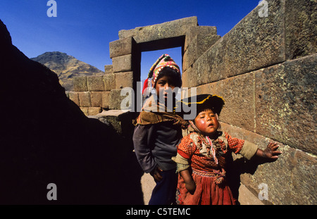 Small boy and girl in indian dress at the Pisac Inka ruins, Peru