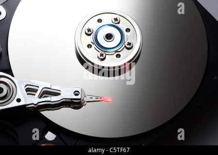 Computer hard drive, opened, reading/writing head and hard disk. Stock Photo
