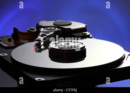 Computer hard drive, opened, reading/writing head and hard disk. Stock Photo