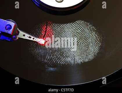 Computer hard drive, opened with writing/reading head and hard disc. Fingerprint on hard disk, symbol photo. Stock Photo