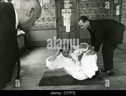 HENRY COOPER (1934-2011) English heavyweight boxer with brother George watched by Manager Jim Wicks Stock Photo