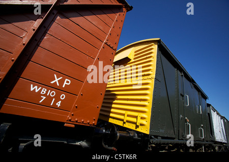 Yellow and terracotta steam train carriages at Levisham Railway Station Ryedale North Yorkshire Moors Stock Photo