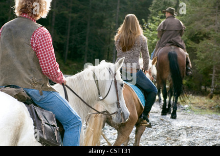 Austria, Salzburger Land, Altenmarkt, Young people horse riding, rear view Stock Photo