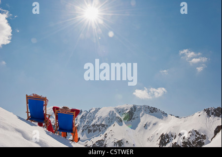 Austria, Salzburger Land, Couple sitting in deck chairs, rear view Stock Photo