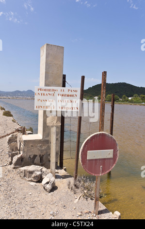 Salt Pans of Parc Natural de Ses Salines near Ibiza city and airport. No entry on causeway to salt processing plant. Stock Photo