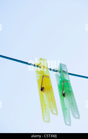 Clothes pegs on clothesline, close-up Stock Photo