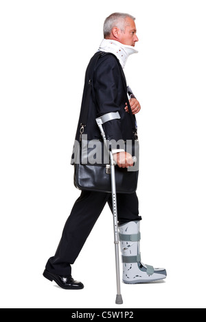 Photo of a badly injured businessman walking on cructhes carrying a briefcase, isolated on a white background. Stock Photo