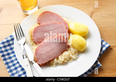 Smoked pork chop, with potatoes and sauerkraut on plate Stock Photo
