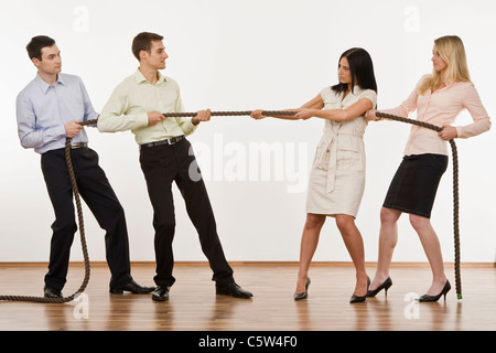 Businesspeople playing tug of war Stock Photo