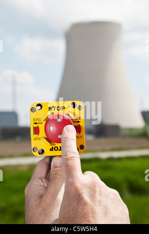 Germany, Bavaria, Unterahrain, Hand of man pressing shut off button near AKW Isar Stock Photo