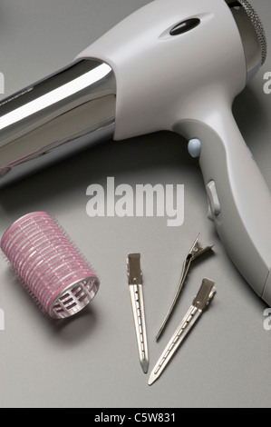 Hair dryer, curler and hair clip, elevated view Stock Photo