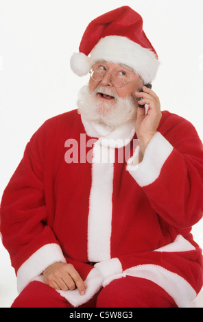 Santa Claus using mobile phone, portrait, close-up Stock Photo