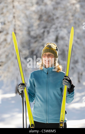 Austria,Tyrol, Seefeld, Wildmoosalm, Woman holding cross-country skis Stock Photo