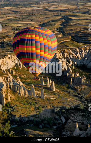 Turkey, Cappadocia, Goreme, View of hot air balloons glides over rocks Stock Photo
