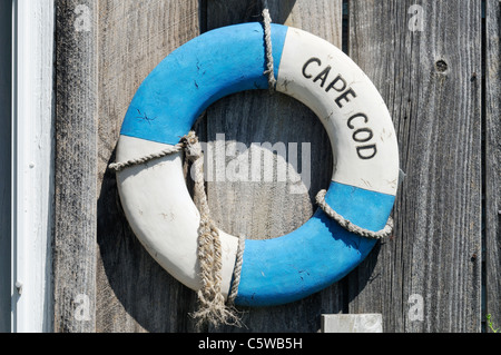 Classic Cape Cod life ring on weathered wood on exterior of building, USA. Stock Photo