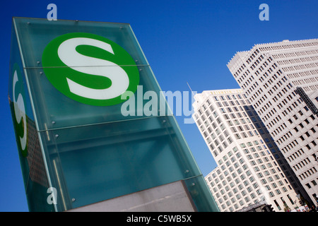 Germany, Berlin, Potsdam Square, Station sign with skyscrapers in background Stock Photo