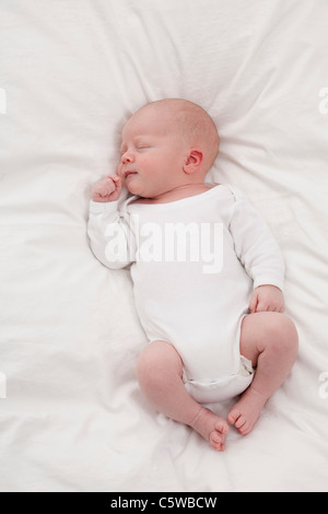 Germany, Munich, (0-1 months) baby boy sleeping on bed Stock Photo