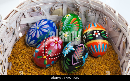 Many colorful eggs in a wicker basket Stock Photo