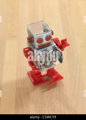 A robot walking on a wooden floor Stock Photo