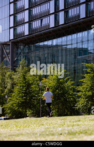 Germany, Berlin, Young man jogging, rear view Stock Photo