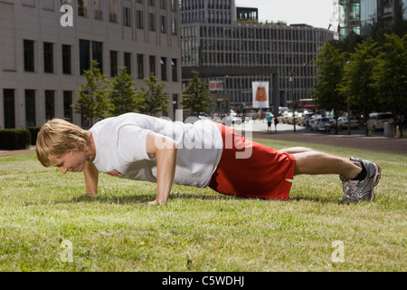 Germany, Berlin, Man doing push-ups, side view Stock Photo