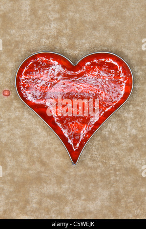 Gelatine flan jelly  in heart shaped baking dish, elevated view Stock Photo