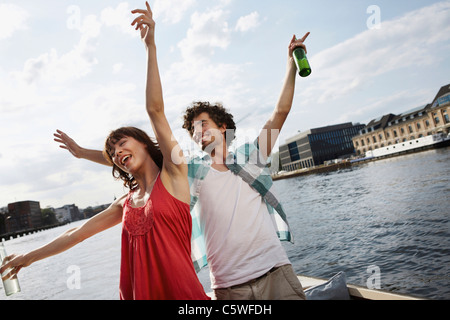 Germany, Berlin, Young couple on motor boat, having fun Stock Photo