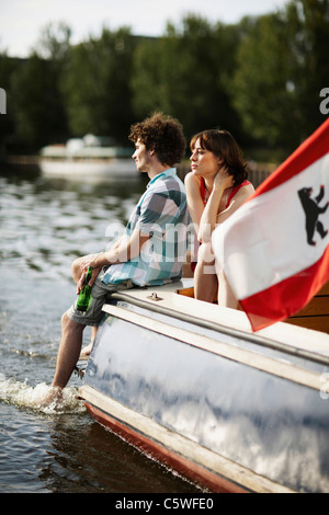 Germany, Berlin, Young couple on motor boat Stock Photo
