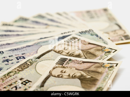 Japanese yen notes fanned out against white background Stock Photo