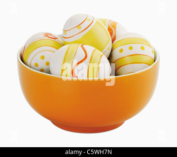 Painted easter eggs in bowl on white background Stock Photo